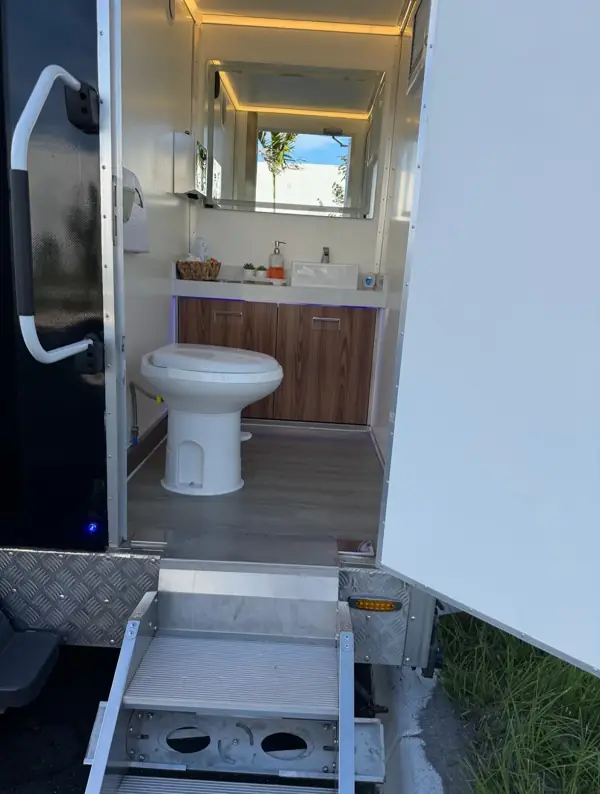 Lit vanity mirror and sink in a luxury restroom