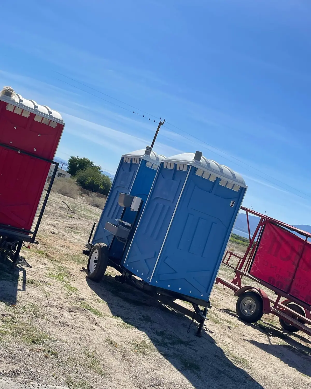 Two portable toilets mounted on a towable trailer